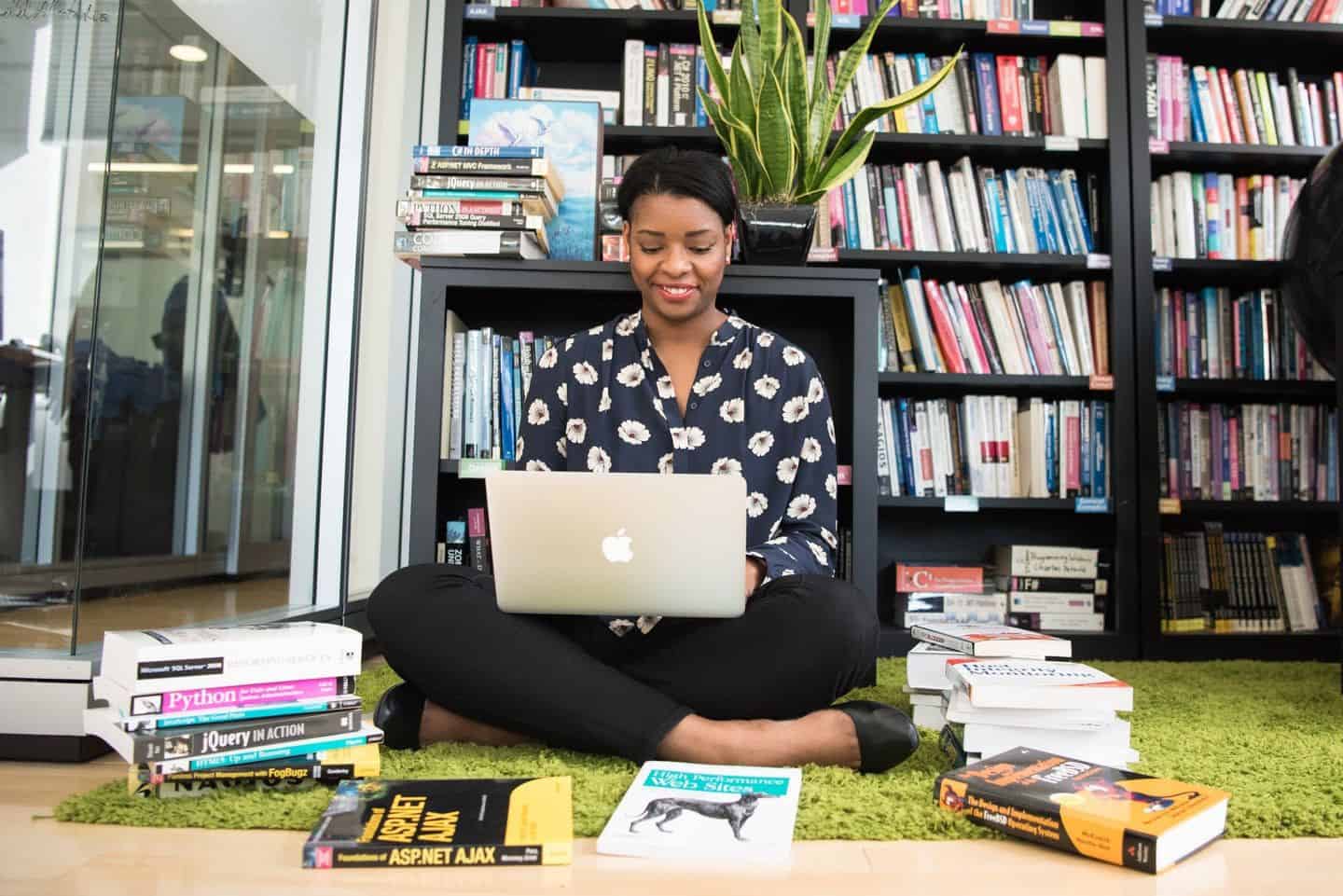 woman listing textbooks to sell online 
