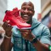man holding discounted basketball shoes