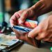 man looking through wallet