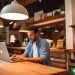 A man working as a one-man Facebook ads agency, managing Facebook ads on his laptop at a cafe.