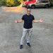 Justin Cambra posing in his vacant lot that he listed on Neighbor.com