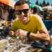 A guy pillaging through a yard sale looking for items he can buy and then sell for a quick profit.