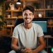 A YouTuber sitting in front of his studio and smiling at the camera.