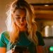 An Instacart worker looking at the Robinhood app on her phone.