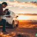 A middle class dad taking a picture of his car that he wants to sell.